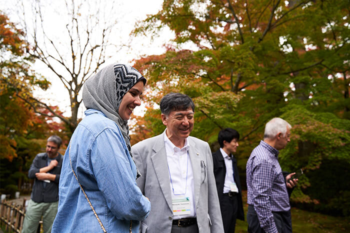 Professor Yamamoto enjoys a moment outside the event with attendees